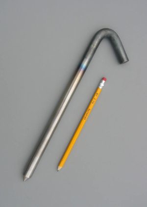 12 inch long unpainted steel hook style stake and a pencil for scale