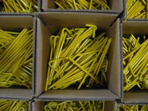 Top view of open boxes of 50 10" yellow tarp stakes